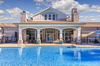 A large house with a pool in front